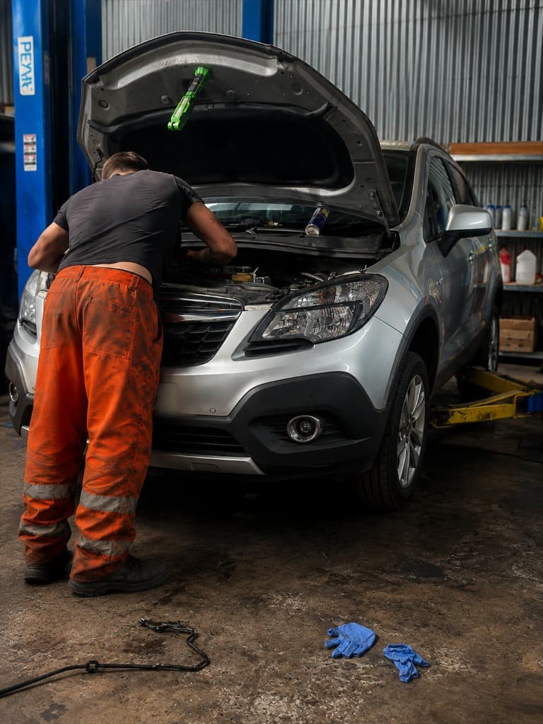 Mechanic working on a vehicle at our workshop